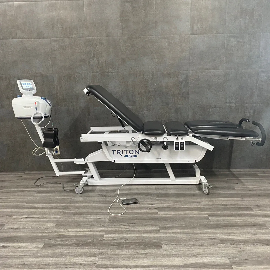 A Triton motorized spinal decompression traction table in the treatment room at Limitless Spine & Joint Care — non-surgical disc therapy in Morganville, NJ.
